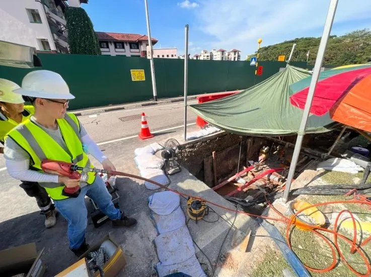 Hydraulic cable cutter being used to safely sever a high voltage cable on site